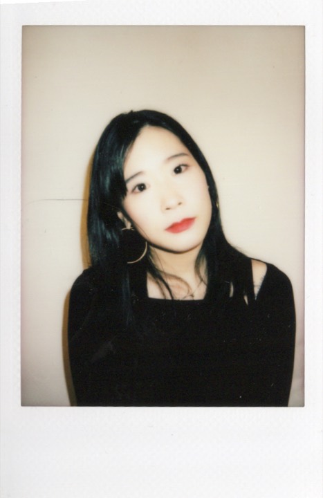 Polaroid portrait in a black dress