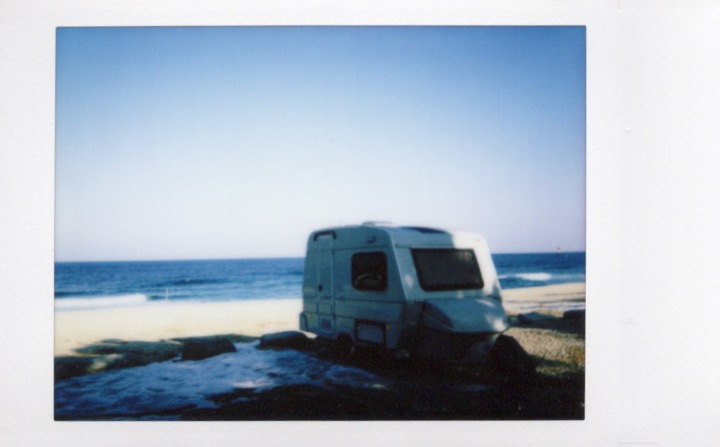 Small caravan parked beside the sea
