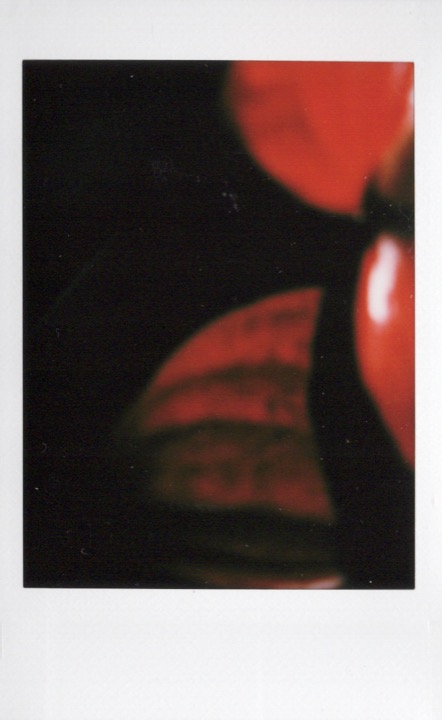 Blurred red-toned abstract Polaroid photographed at night
