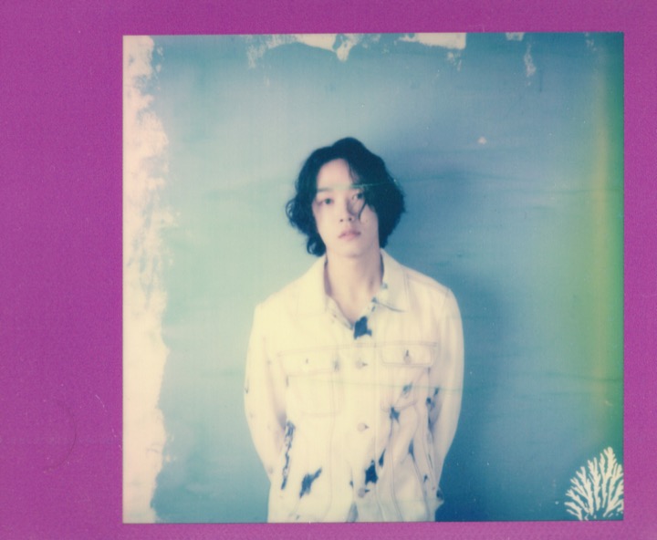 Front-facing portrait framed by a magenta Polaroid border