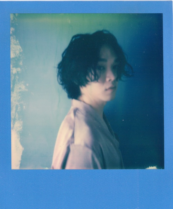 Soft profile portrait with a blue border