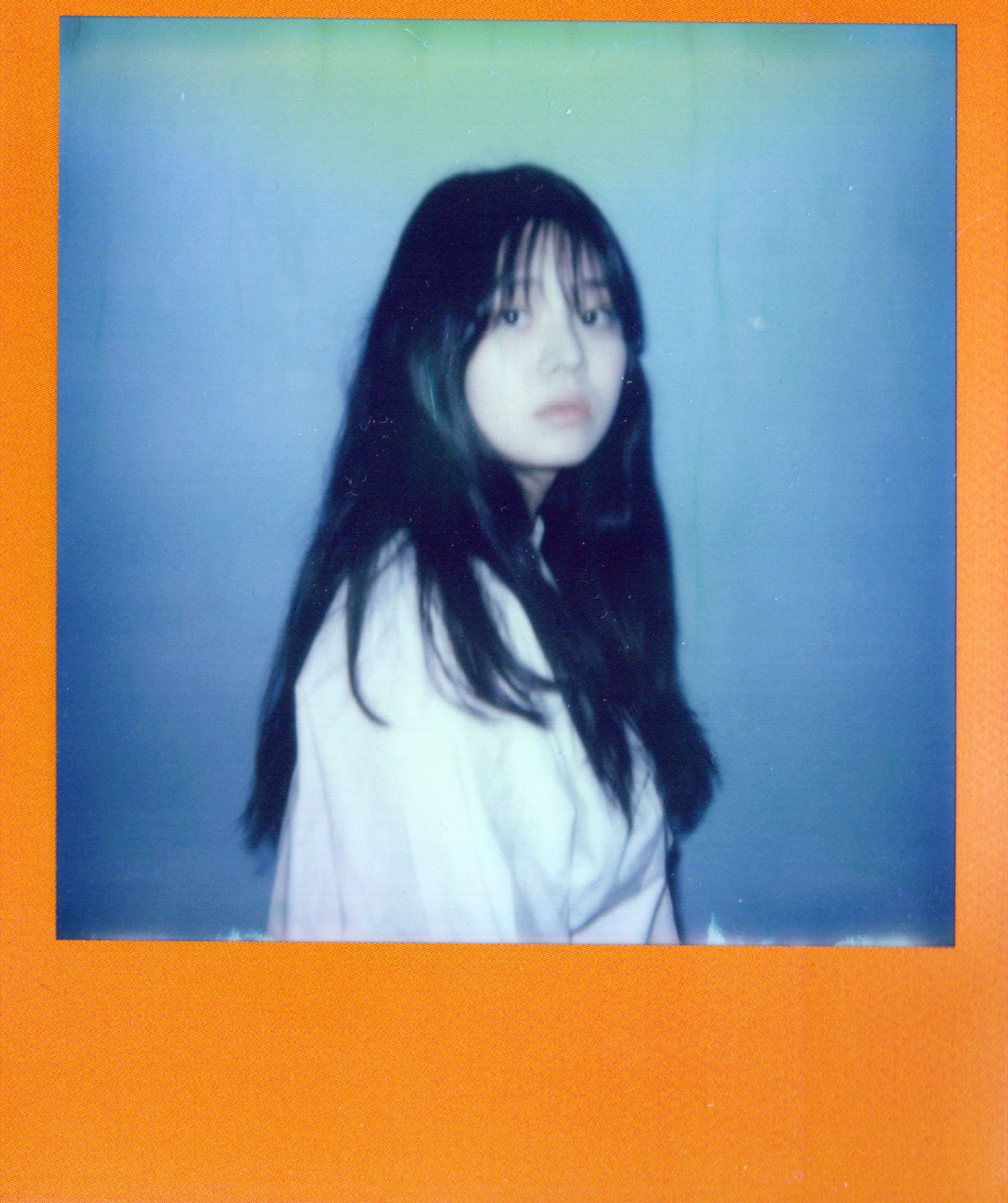 Portrait with an orange Polaroid border