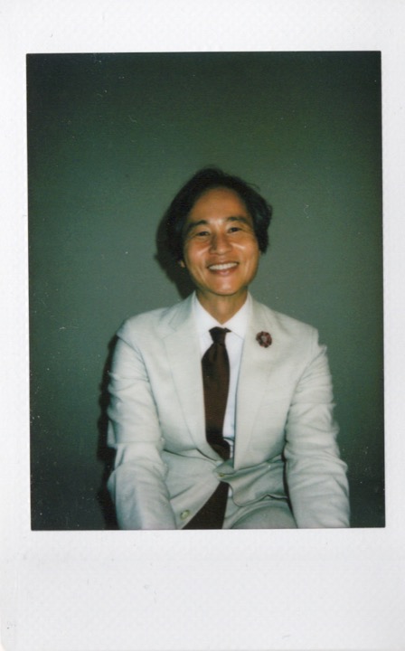 Smiling portrait of a man in a white suit