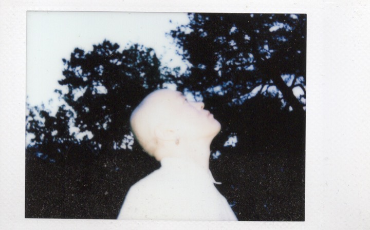 Polaroid portrait obscured by a strong dark shape
