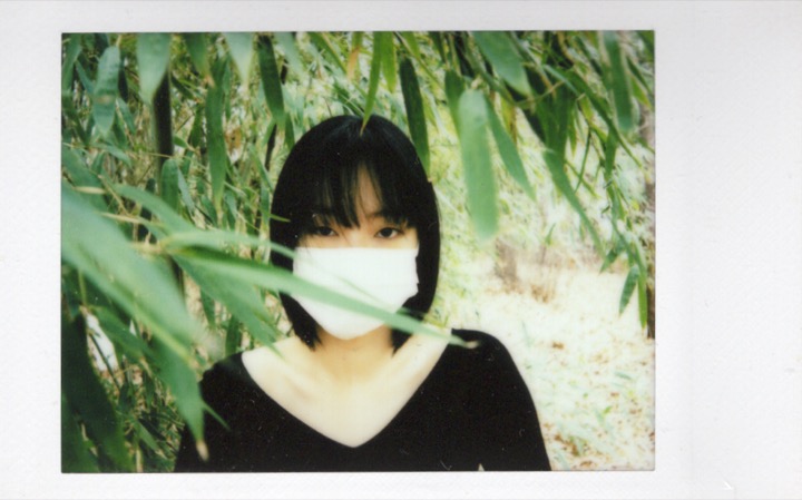 Polaroid portrait where the face is pressed to the frame edge