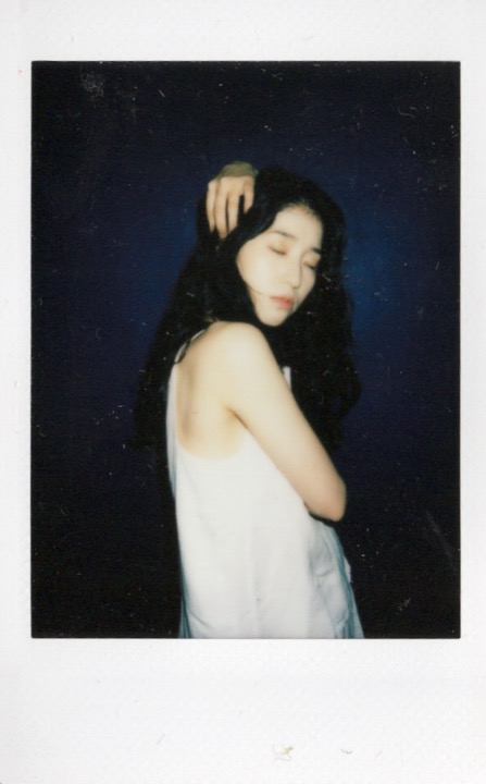 Polaroid portrait against a dark backdrop