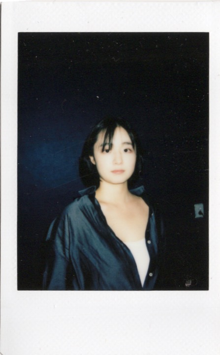 Polaroid portrait with theatrical light and shadow