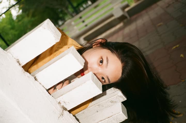 Close portrait of a person partly hidden by a white structure