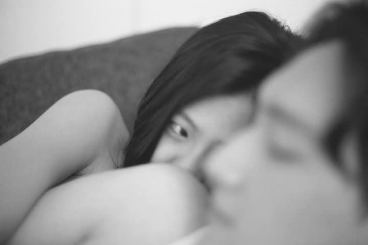 Black-and-white close-up of two people resting together
